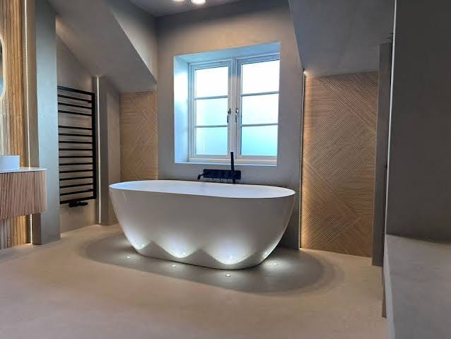 Freestanding bath with floor lighting in an architectural bathroom