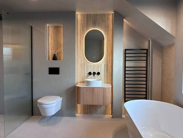 Warm contemporary bathroom suite with illuminated vanity