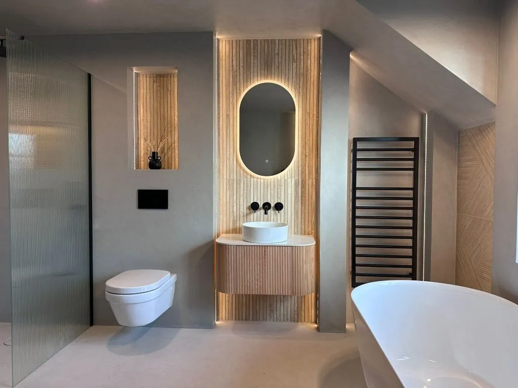 Illuminated timber vanity and oval mirror in a contemporary bathroom